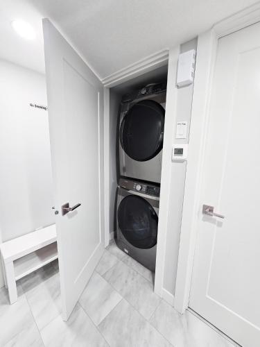 a laundry room with a washer and dryer at Superior and Spacious 2-bedroom basement private suite in Edmonton