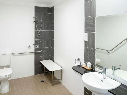 a bathroom with a toilet and a sink and a shower at The Sebel Kiama in Kiama