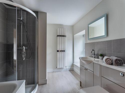 a white bathroom with a shower and a sink at 4 Bed in New Quay 78801 in Llandyssiliogogo