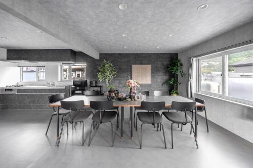 a kitchen and dining room with a table and chairs at The Arklune in Sapporo