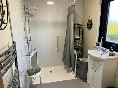 a bathroom with a shower and a sink at 3 Bed in Port William 87541 in Mochrum