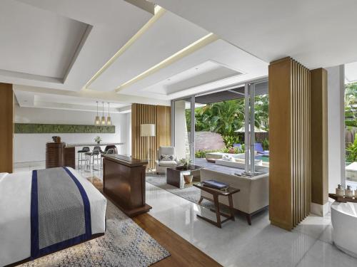 a bedroom with a bed and a living room at Sofitel Bali Nusa Dua Beach Resort in Nusa Dua