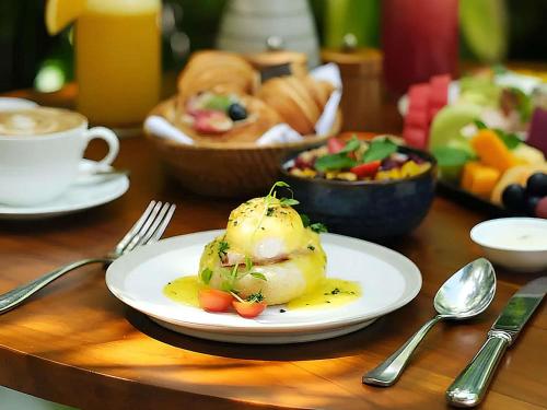 a table with a plate of food on a table at Sofitel Bali Nusa Dua Beach Resort in Nusa Dua