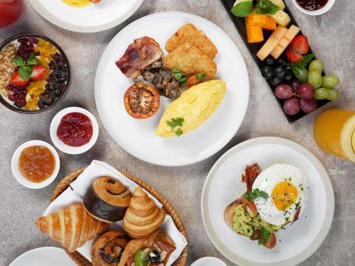 a table with plates of breakfast food on it at Sofitel Bali Nusa Dua Beach Resort in Nusa Dua