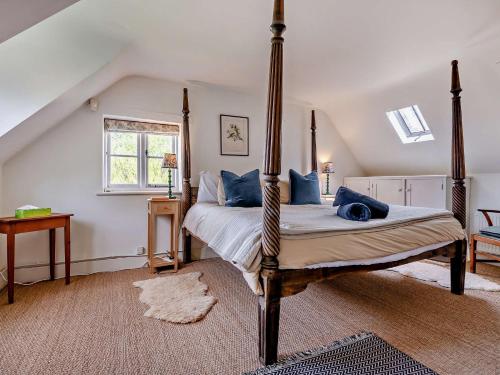 a bedroom with a four poster bed in a attic at 5 Bed in Sturminster Newton 76458 in Lydlinch