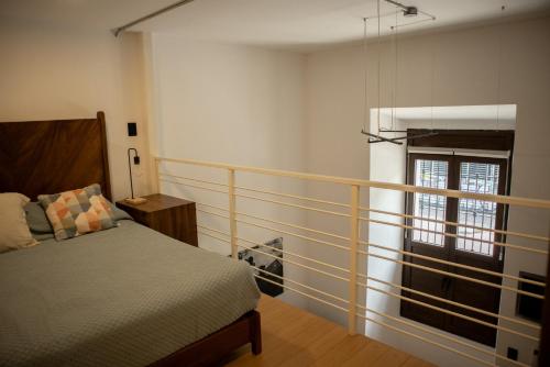 a bedroom with a bed and a window at Calle y Número, López Cotilla in Guadalajara