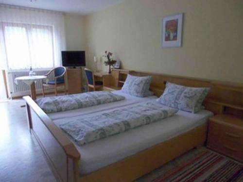 a bedroom with two beds in a room at Landgasthaus zum Engel in Freiamt