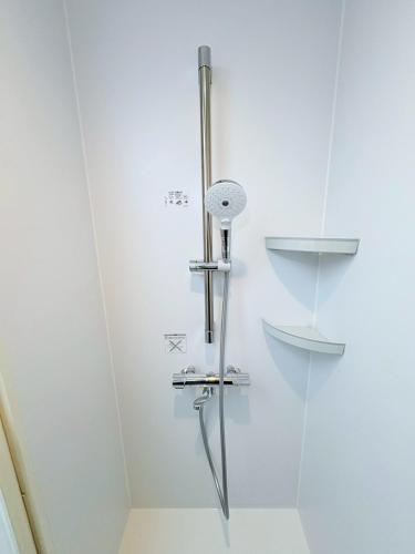 a shower in a bathroom with a glass door at GARDEN HOUSE Tameike-Sanno in Tokyo