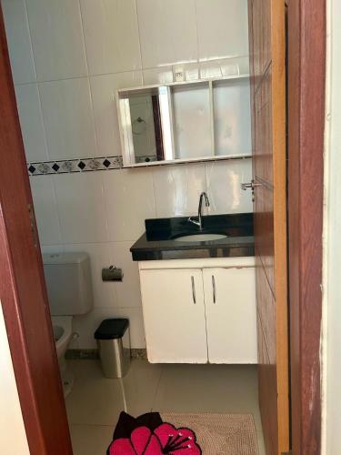 a small bathroom with a sink and a toilet at Apê VistaBella seu refúgio no Caparaó in Alto Caparao