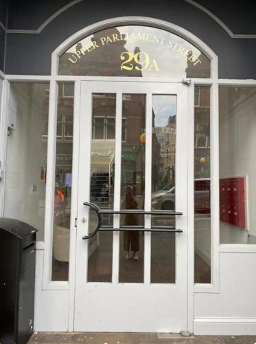 a dog standing in the doorway of a store at Quiet & Modern Studio in the Heart of Nottingham City Centre in Nottingham