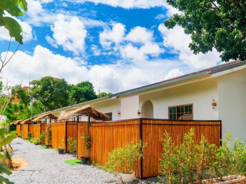 a row of fences in front of a house at Patcharapon Resort in Ban Pong
