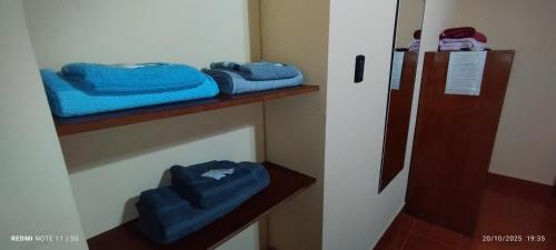 a room with some blue towels on a shelf at Alojamiento Temporal MartinaS in San Fernando del Valle de Catamarca