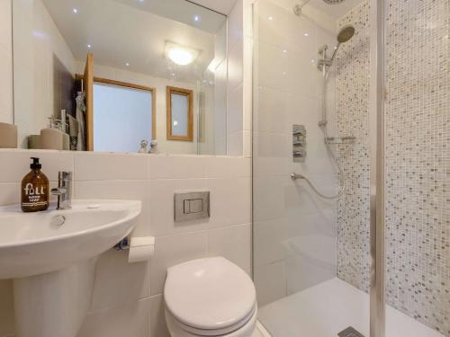 a white bathroom with a toilet and a shower at 3 Bed in Croyde 90437 in Croyde