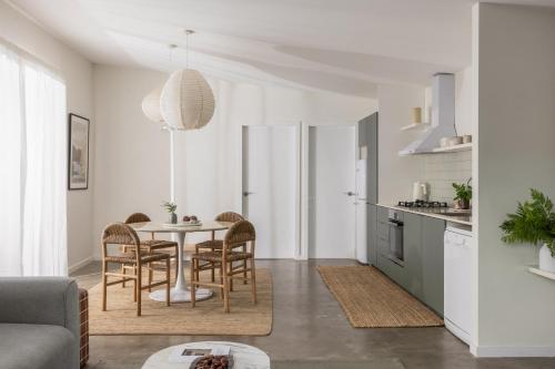 a kitchen and dining room with a table and chairs at The Local House - Byron Bay in Byron Bay