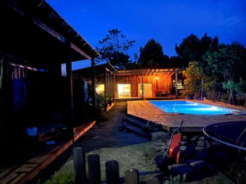 a backyard with a swimming pool at night at Cielo abierto in Maldonado