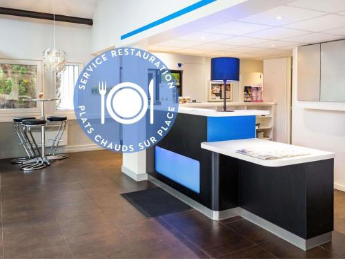 a kitchen with a sign in the middle of a room at Hôtel Ibis Budget Nantes Ouest Atlantis Couëron in Couëron
