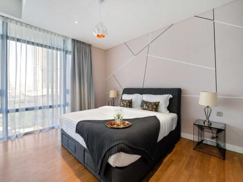 a bedroom with a large bed with a large window at Leo Guesthouse in Kuala Lumpur
