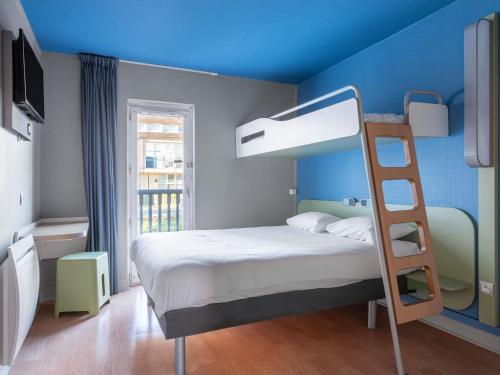 a bedroom with a bunk bed with a ladder at ibis budget Caen Hérouville in Hérouville-Saint-Clair