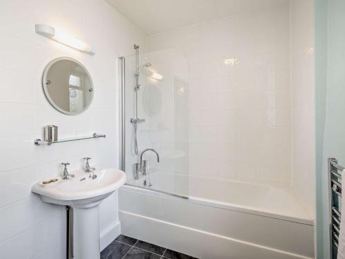 a white bathroom with a sink and a bath tub at 2 Bed in Outgate and Tarn Hows LLH01 in Hawkshead