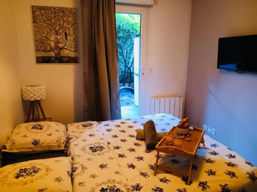 a bedroom with a bed and a table on it at Habitation Keira in Saint-Denis