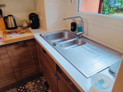 a kitchen with a sink and a counter at Habitation Keira in Saint-Denis