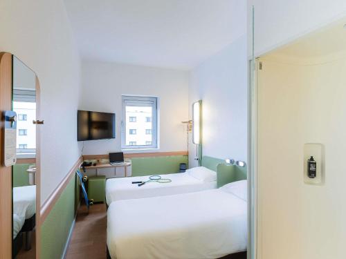 Postel nebo postele na pokoji v ubytování Hotel ibis Budget Porto Gaia