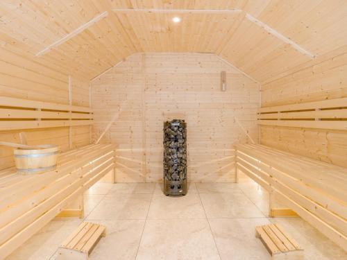 a large wooden sauna with wooden benches in it at 7 Bed in Whitchurch 95835 in Prees