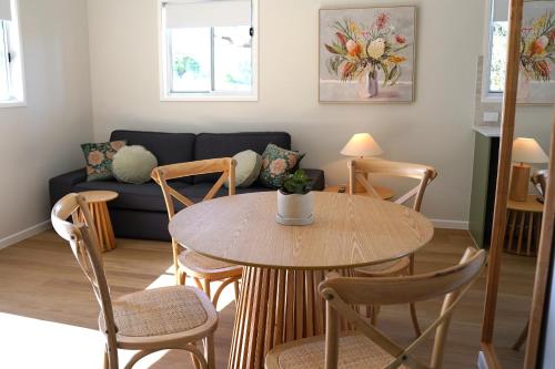 a living room with a table and chairs and a couch at Sunshine Coast Hinterland Retreat - Yandina Station in Yandina Creek