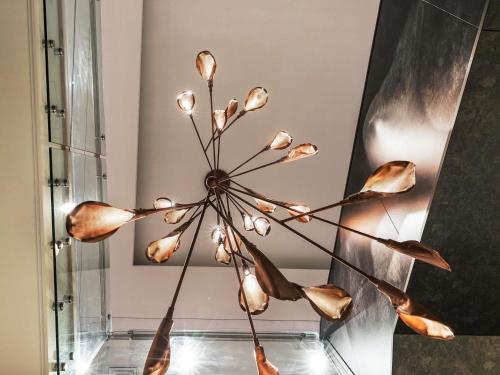 a vase with a flower sculpture in a room at Sofitel Wellington in Wellington