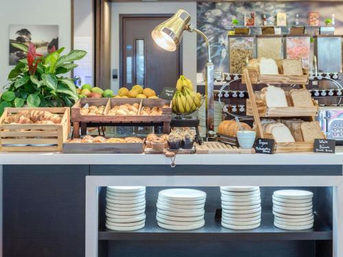 a counter with plates and other food on display at Mercure Edinburgh Haymarket in Edinburgh