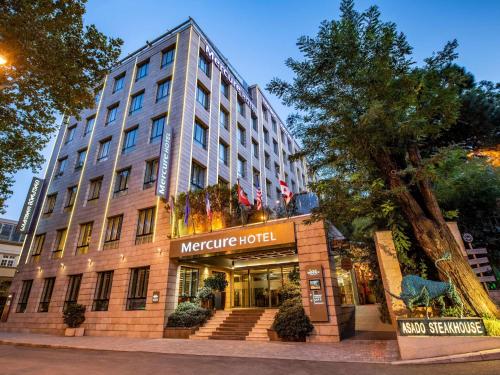 a moderne hotel on the corner of a street at Mercure Tbilisi Old Town in Tbilisi City