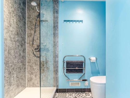 a bathroom with a glass shower with a toilet at 1 Bed in Bovey Tracey BBELL in Hennock