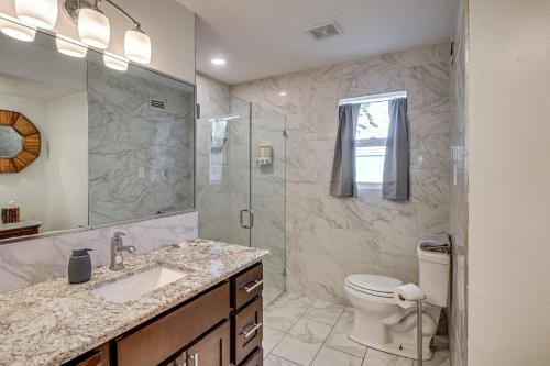 a bathroom with a shower and a toilet and a sink at 3 Mi to Beach and Boardwalk Riverfront Daytona Home in Holly Hill
