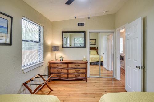 a room with a dresser and a bedroom with a mirror at 3 Mi to Beach and Boardwalk Riverfront Daytona Home in Holly Hill
