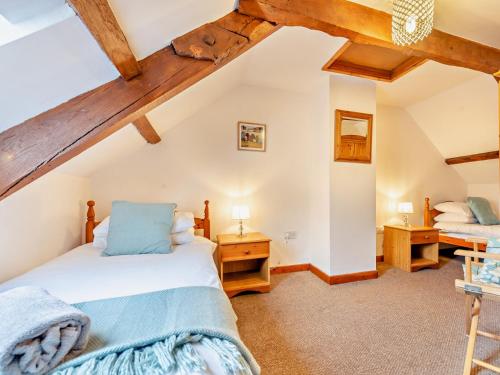 a bedroom with two beds in a attic at 4 Bed in Llandovery 82440 in Llanfair-ar-y-bryn
