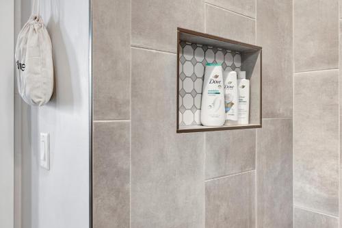 a bathroom with a shower with two bottles of soap at Brazos - A Birdy Vacation Rental in Fredericksburg