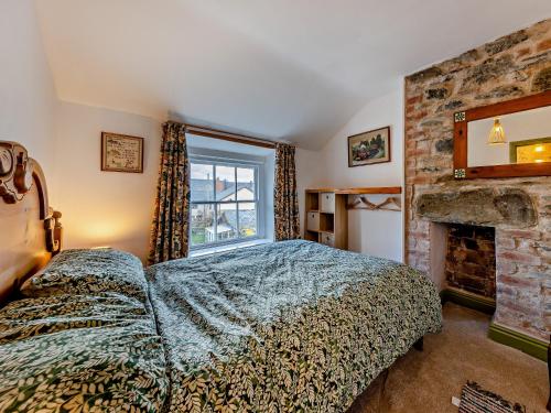 a bedroom with a bed and a fireplace at 4 Bed in Bala 94665 in Bala