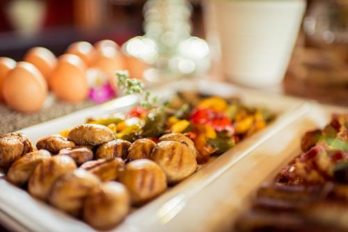 a tray of food on a table with eggs at Hotel Wegner - T h e culinary art hotel in Hannover