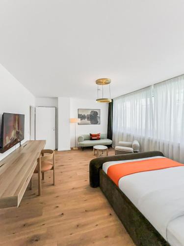 a bedroom with a bed and a living room at Chic City Apartment, 1BR for 2, Elegant Comfort, City Center in Wuppertal