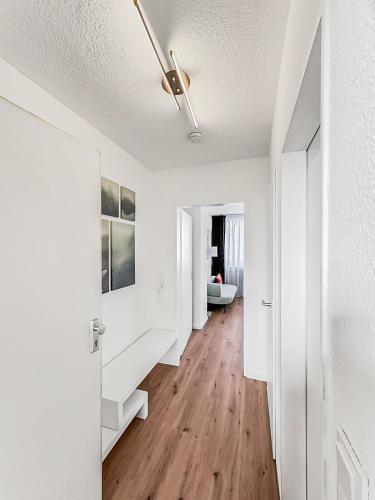 a hallway with white walls and a ceiling at Chic City Apartment, 1BR for 2, Elegant Comfort, City Center in Wuppertal