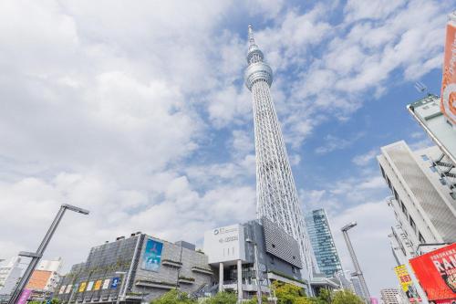 a tall tower in a city with buildings at Daffitto Oshiage II in Tokyo