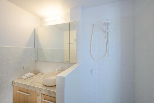 a white bathroom with a sink and a shower at Ocean Vista Apartment, Sunrise Beach in Sunrise Beach