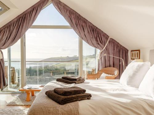 a bedroom with a bed and a large window at 4 Bed in Wembury 54383 in Wembury