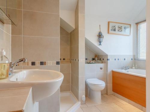 a bathroom with a sink and a toilet at 4 Bed in Wembury 54383 in Wembury