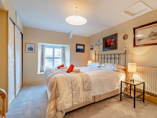 a bedroom with a large bed and a window at 3 Bed in Talyllyn 93947 in Llanywern