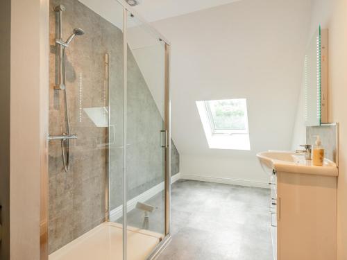 a bathroom with a glass shower and a sink at 5 Bed in Builth Wells 92709 in Beulah