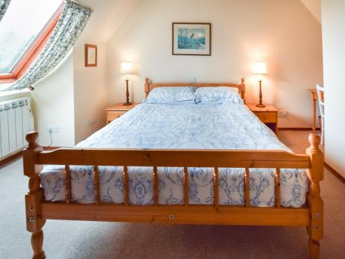 a bedroom with a wooden bed with two night stands at 5 Bed in Roshven CA231 in Glenuig