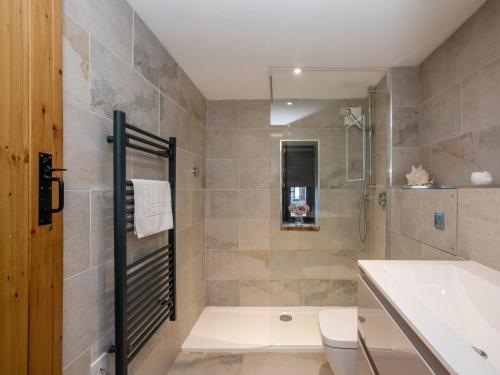 a bathroom with a shower and a toilet and a sink at 2 Bed in Holt NCC41 in Holt