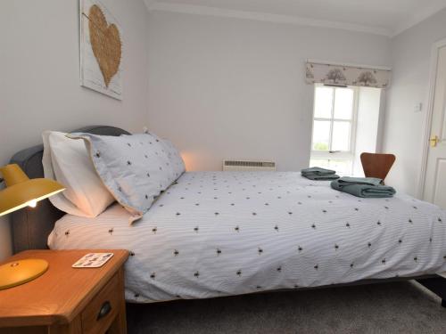 a bedroom with a bed and a desk and a window at 1 Bed in Biggar 82923 in Biggar