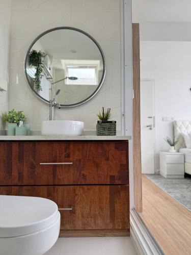 a bathroom with a sink and a mirror at Nala Host- 2BR Beachfront Apartment in Male City